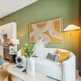 a living room with a couch and a green wall